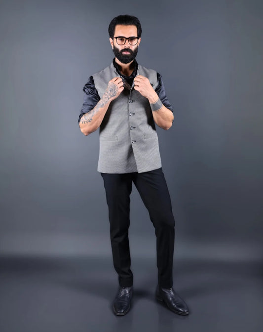 Man wearing a gray nehru jacket with a black shirt