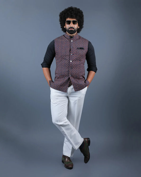 Man wearing a navy blue printed Nehru jacket with white trousers