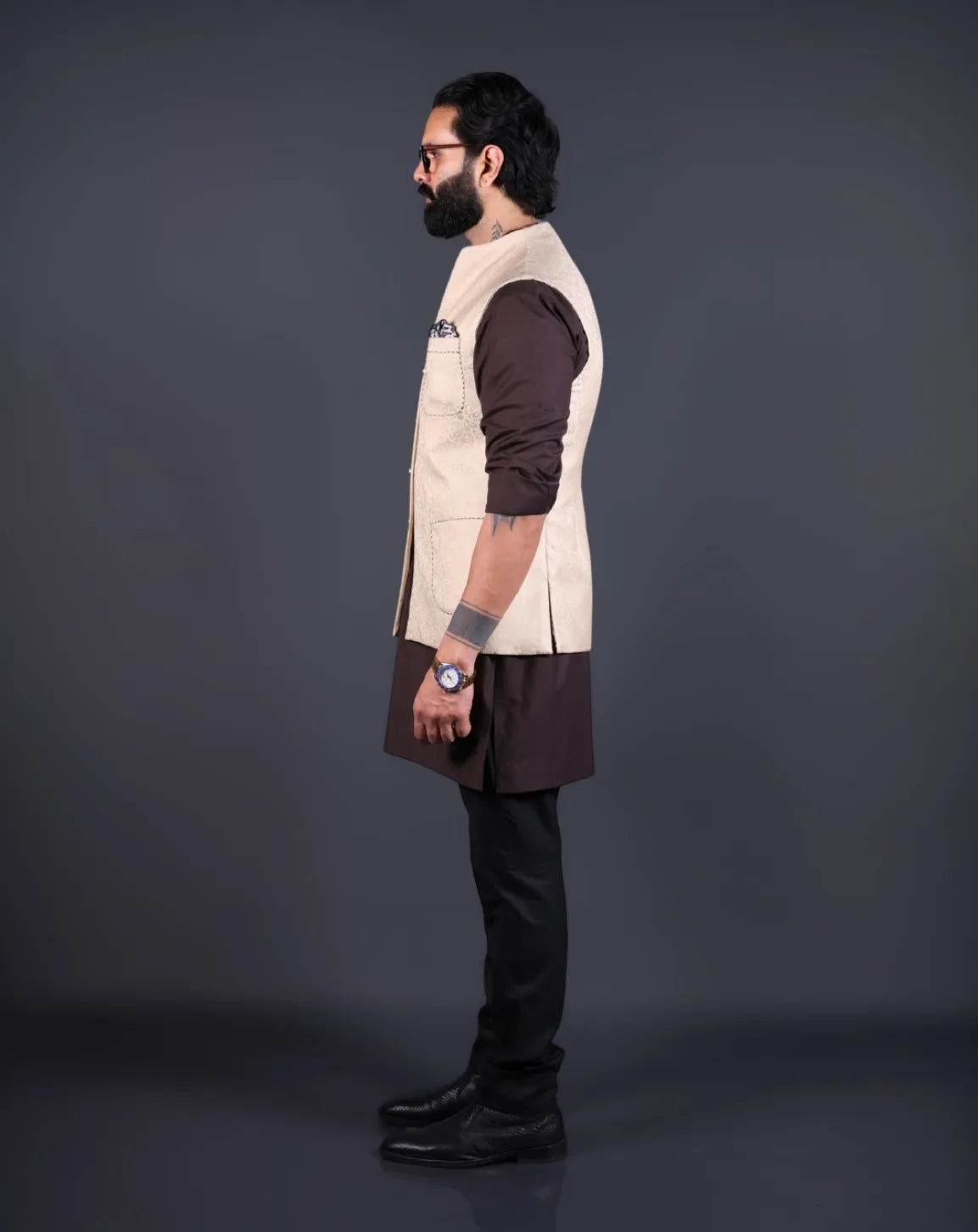 Model wearing a stylish jacquard patterned Nehru jacket for men over a brown kurta.