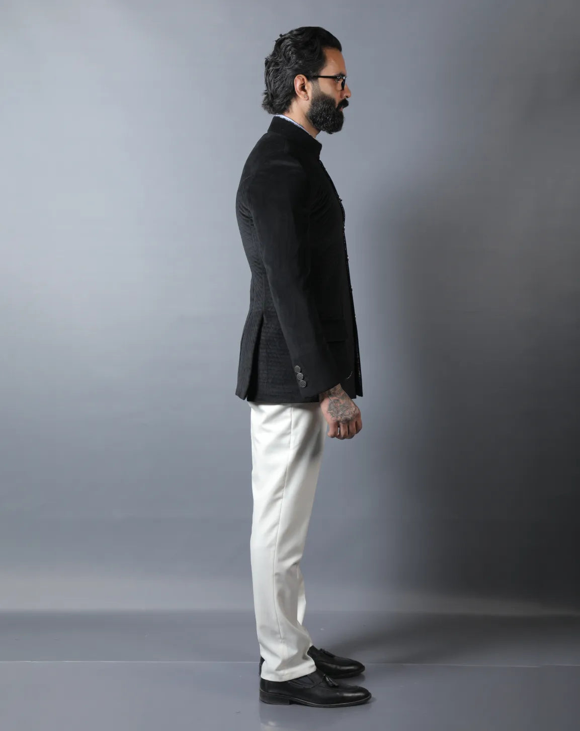 Man wearing a black blazer and white pants