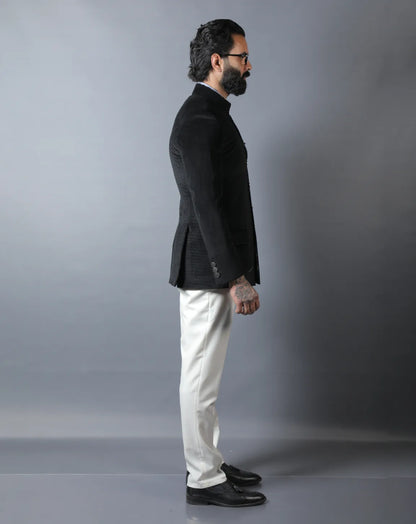 Man wearing a black blazer and white pants