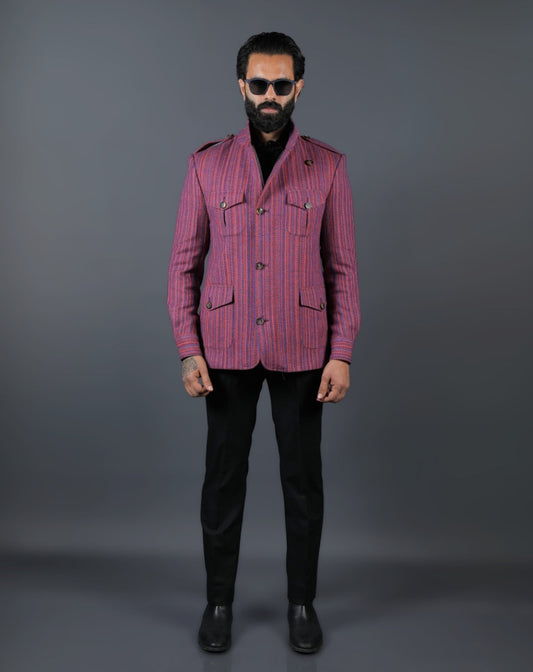 Man wearing a pink striped jacket and black pants 