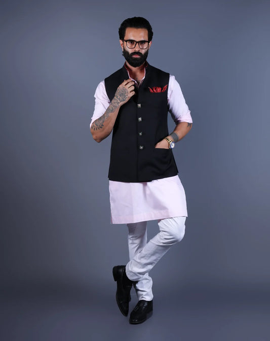 Front view of a man in a black Nehru jacket and pink kurta