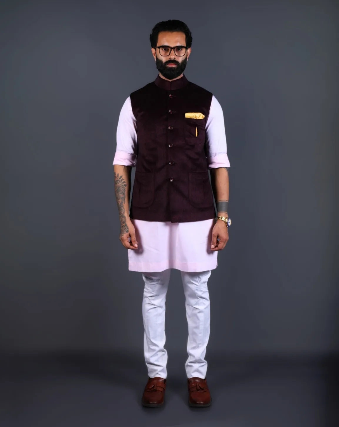 Man wearing a wine velvet Nehru jacket with golden pocket square