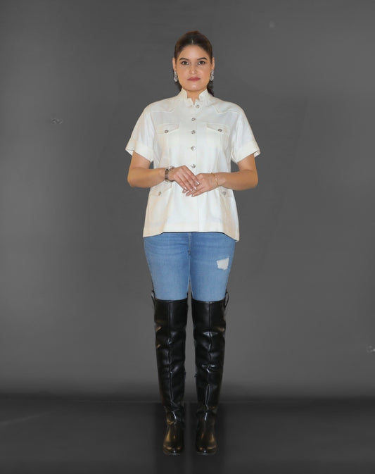 Woman wearing a white hunting bush shirt.