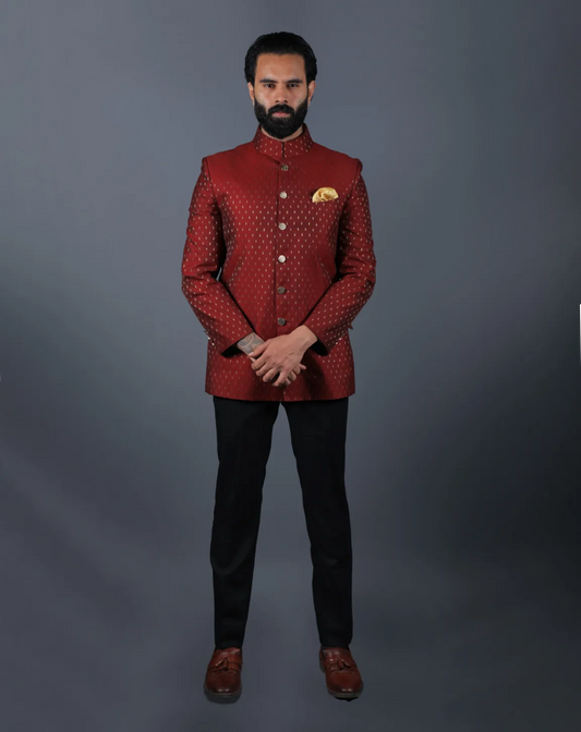Front view of model standing in a maroon woven Jacquard Bandhgala suit.