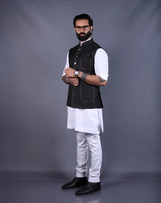 Full-length view of a black Nehru jacket paired with a white kurta